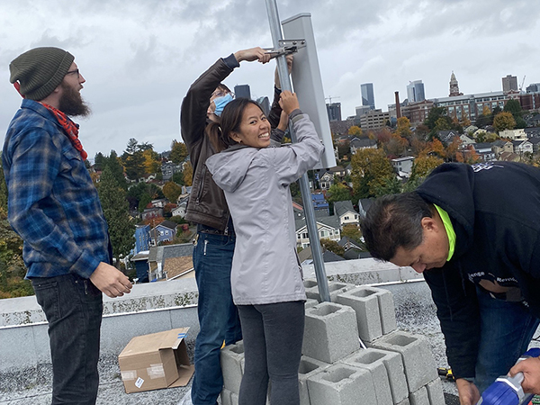 group-lab-ictd A group of four students erect community broadband networking apparatus on a rooftop